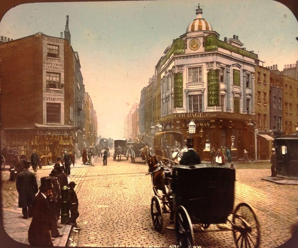 Hand coloured lantern slide of Seven Dials with horse drawn carriage, 1890