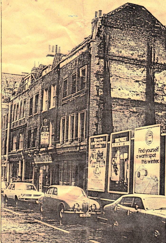 Photograph showing the semi-derelict state of Monmouth Street c. 1960