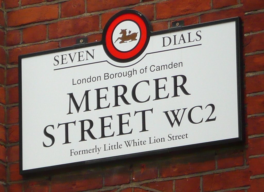 Seven Dials street name plate. Text reads Seven Dials. London Borough of Camden. Mercer Street WC2, formerly Little White Lion Street.